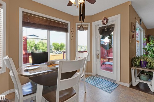 Dining area with large windows, durable tile flooring, and direct access to an outdoor space - 1216 37C Avenue Nw, Edmonton, AB - Indoor Photo Showing Dining Room
