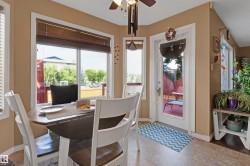 Dining area with large windows, durable tile flooring, and direct access to an outdoor space - 
