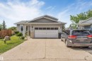 Single-story residence featuring light gray siding and a gray shingle roof - 3332 43 Street, Edmonton, AB 