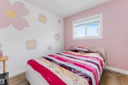 Bright room featuring a window with white trim, light-colored wood-finish flooring, and white baseboards - 