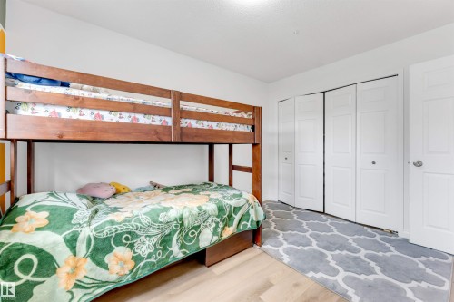 Bright interior room with wood-finish flooring, white walls, and a white ceiling - 3332 43 Street, Edmonton, AB 