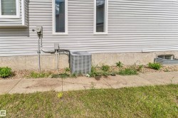 Exterior siding with white trim windows and a concrete foundation - 