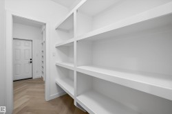 Built-in white shelving providing extensive storage - 