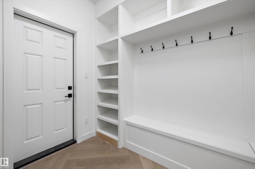 Entryway featuring built-in shelving, seating, and coat hooks - 917 Elderberry Landing, Edmonton, AB 