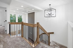 Upper-level landing featuring a coffered ceiling with recessed lighting - 