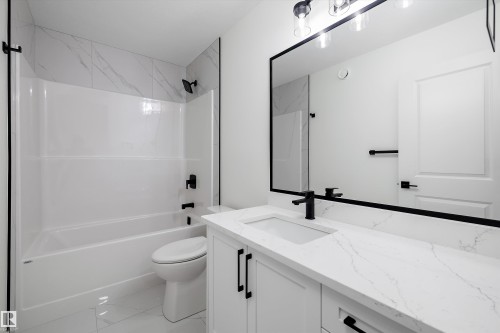 White vanity with a rectangular undermount sink, a white countertop, and matte black hardware - 917 Elderberry Landing, Edmonton, AB 