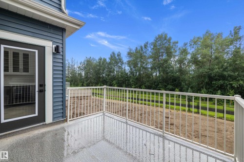 Outdoor balcony featuring durable non-slip flooring and white metal railing - 917 Elderberry Landing, Edmonton, AB 
