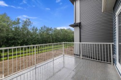 Private balcony featuring a textured gray surface and a white metal railing - 