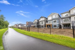 Modern residential development featuring multi-story homes with varied siding colors and private balconies - 