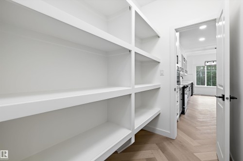 Built-in pantry shelving featuring white finishes and ample storage capacity - 917 Elderberry Landing, Edmonton, AB 