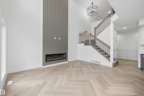Herringbone wood-finish flooring extending through the space - 917 Elderberry Landing, Edmonton, AB 