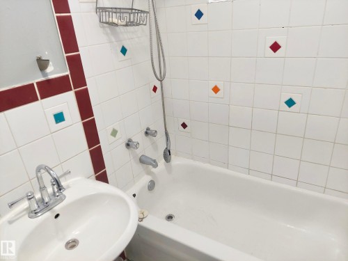 White ceramic tile shower surround with accent tiles and a built-in tub - 11238 123 Street, Edmonton, AB 