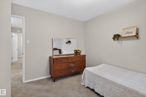 Neutral-toned walls complement the textured ceiling and carpeted flooring - 17603 85 Avenue Nw, Edmonton, AB 