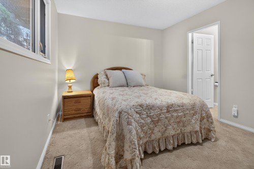 Neutral-toned room with plush carpeting and a white trim baseboard - 17603 85 Avenue Nw, Edmonton, AB 