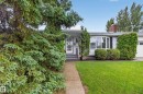 Ranch-style residence featuring a prominent bay window, white siding, and a brick chimney - 17603 85 Avenue Nw, Edmonton, AB 