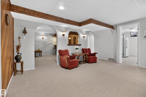 Archway openings with decorative sconces and a built-in bar area - 17603 85 Avenue Nw, Edmonton, AB 