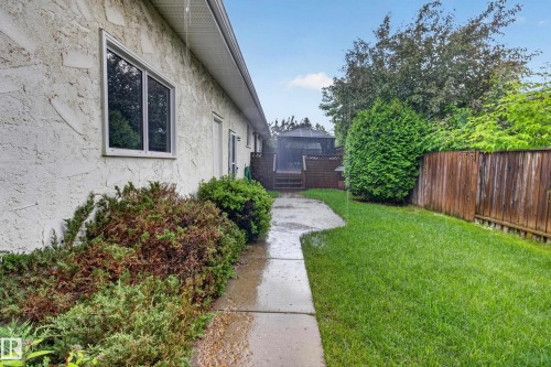 Landscaped exterior featuring a stucco facade and a concrete walkway - 17603 85 Avenue Nw, Edmonton, AB 