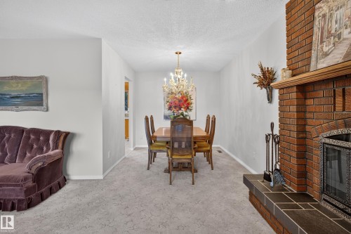 Formal dining space featuring a brass chandelier with candelabra bulbs - 17603 85 Avenue Nw, Edmonton, AB 