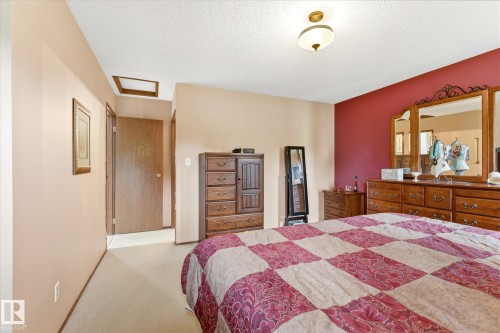 Carpeted bedroom featuring a textured ceiling, a flush-mount light fixture, and a recessed ceiling panel - 59 Patterson Crescent, St. Albert, AB - Indoor Photo Showing Bedroom