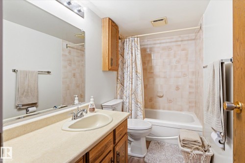 Bathroom featuring a vanity with an integrated sink, wood-finish cabinetry, and a full-width mirror - 59 Patterson Crescent, St. Albert, AB - Indoor Photo Showing Bathroom