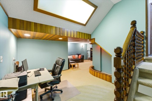 Carpeted staircase with an ornate wooden balustrade - 59 Patterson Crescent, St. Albert, AB - Indoor Photo Showing Office
