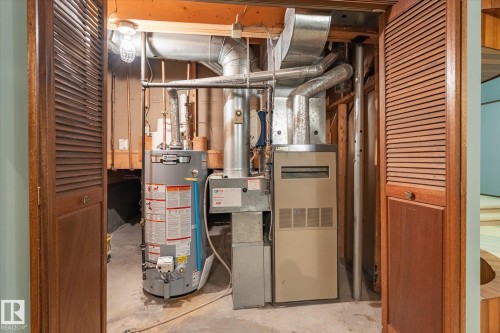 Utility closet featuring a water heater, furnace, and exposed ductwork - 59 Patterson Crescent, St. Albert, AB - Indoor Photo Showing Basement