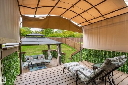 Multi-level wood deck featuring a covered pergola with retractable shades and a separate metal gazebo - 59 Patterson Crescent, St. Albert, AB - Outdoor With Deck Patio Veranda With Exterior