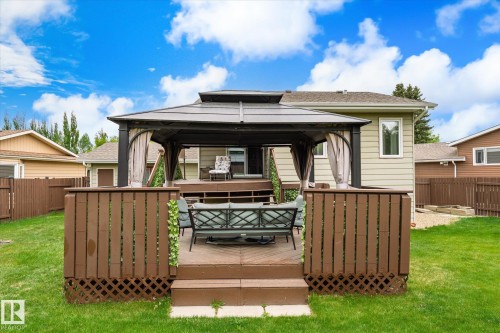 Outdoor deck with a gazebo structure, wood privacy fencing, and a manicured lawn - 59 Patterson Crescent, St. Albert, AB - Outdoor With Deck Patio Veranda