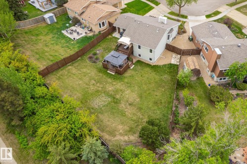 Expansive backyard featuring a large green space, a multi-level deck with a built-in gazebo, and mature perimeter trees - 59 Patterson Crescent, St. Albert, AB - Outdoor With View