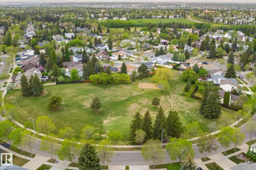 Expansive community green space with mature trees, surrounded by residential properties and paved streets - 59 Patterson Crescent, St. Albert, AB - Outdoor With View