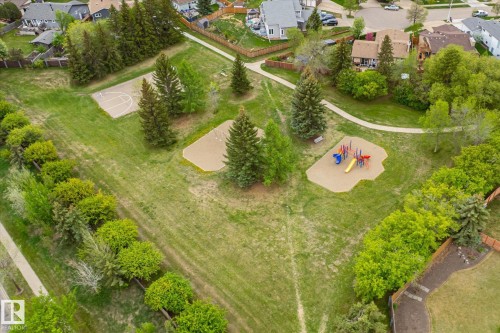 Expansive green space featuring mature trees, a children's play structure, and a hardcourt area - 59 Patterson Crescent, St. Albert, AB - Outdoor With View