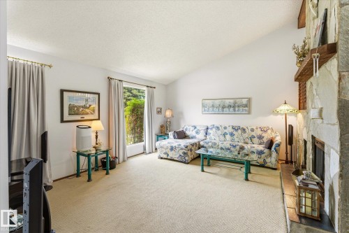 Living room featuring a vaulted ceiling and light-toned carpet - 59 Patterson Crescent, St. Albert, AB - Indoor Photo Showing Living Room