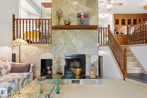 Floor-to-ceiling stone fireplace featuring a wood mantle and hearth - 59 Patterson Crescent, St. Albert, AB - Indoor With Fireplace