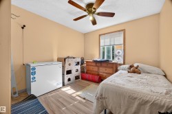 Room featuring wood-finish flooring, a window with natural light, and a ceiling fan with integrated lighting - 