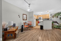 Open-concept living area with wood-finish flooring - 