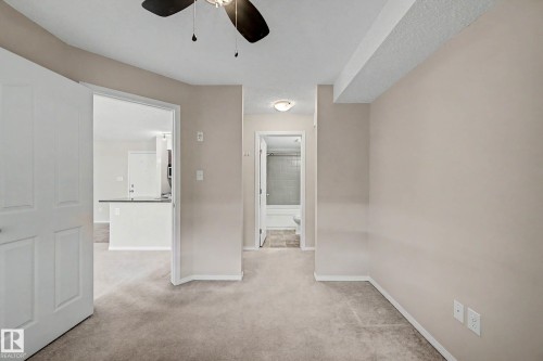 Carpeted interior space with a ceiling fan light fixture - 404 1080 Mcconachie Boulevard, Edmonton, AB 