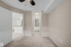 Carpeted interior space with a ceiling fan light fixture - 