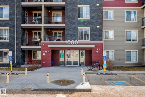 Multi-story residential building featuring a stone facade and horizontal siding - 404 1080 Mcconachie Boulevard, Edmonton, AB 