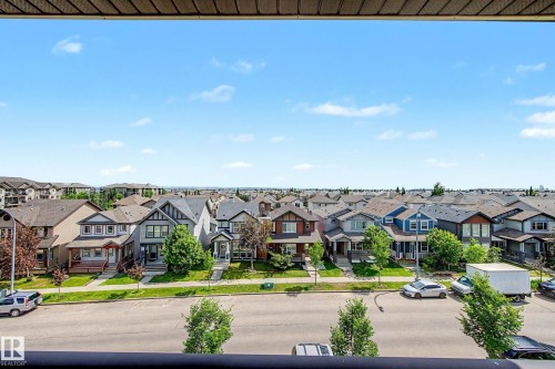 Expansive residential streetscape featuring numerous multi-story homes with varied architectural styles and pitched roofs - 404 1080 Mcconachie Boulevard, Edmonton, AB 