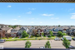 Expansive residential streetscape featuring numerous multi-story homes with varied architectural styles and pitched roofs - 