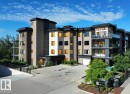 Contemporary multi-story building featuring varied facade materials including stucco and stone-finish panels - 211 5029 Edgemont Boulevard, Edmonton, AB 