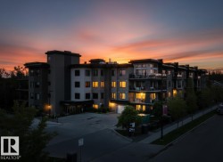Modern residential building featuring multi-story construction, balconies with glass railings, and a contemporary facade - 