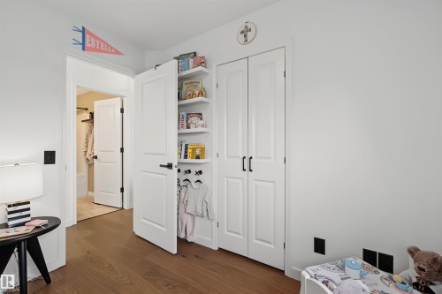 Warm wood-finish flooring complements crisp white walls - 15 450 Hyndman Crescent, Edmonton, AB 