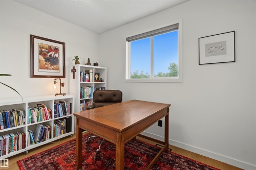 Bright room featuring light wood-finish flooring and white walls - 15 450 Hyndman Crescent, Edmonton, AB 