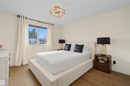 Cream walls with wood-finish flooring - 15 450 Hyndman Crescent, Edmonton, AB 