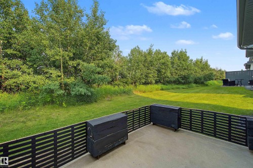 Private patio featuring a concrete surface and slatted black fencing - 15 450 Hyndman Crescent, Edmonton, AB 