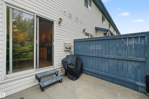Paved patio area featuring privacy fencing - 15 450 Hyndman Crescent, Edmonton, AB 