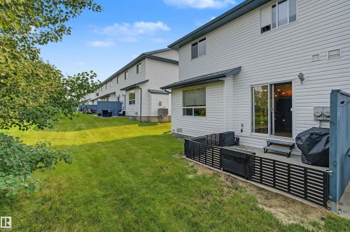 Expansive green lawn backing to additional properties - 15 450 Hyndman Crescent, Edmonton, AB 
