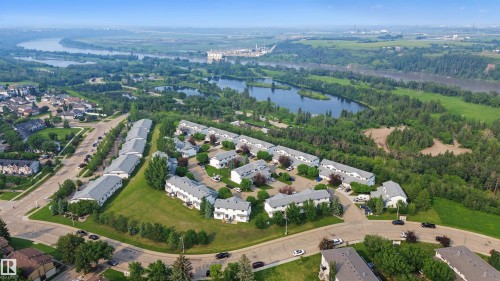 Aerial perspective showcasing a residential community surrounded by mature trees - 15 450 Hyndman Crescent, Edmonton, AB 