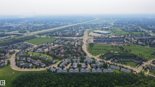 Aerial perspective showcasing residential developments interspersed with green spaces and established road infrastructure - 15 450 Hyndman Crescent, Edmonton, AB 